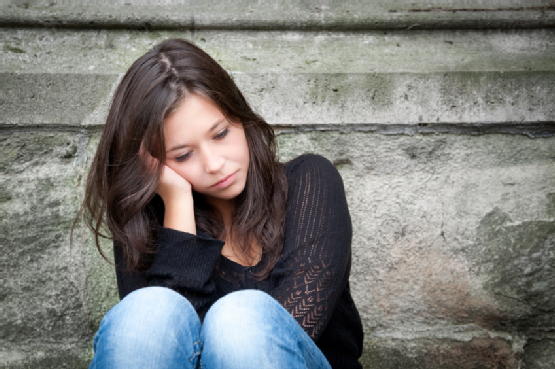 Teenage girl looking thoughtful about troubles