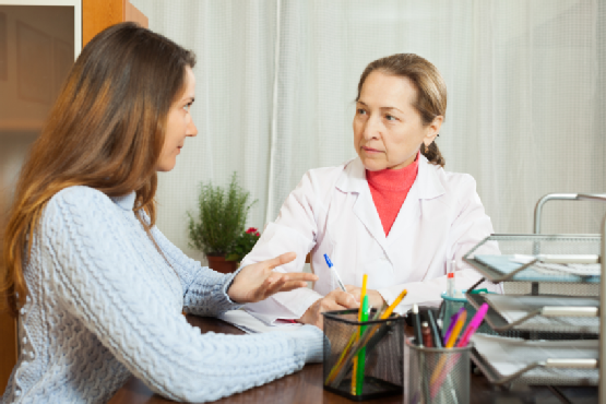 Woman doctor and teenager patient