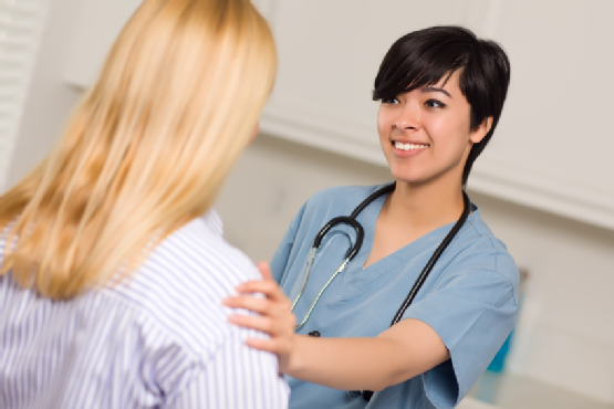 Attractive Multi-ethnic Young Female Doctor Talking with Patient
